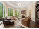 Gathering room with fireplace, large windows, and comfortable seating at 6092 Carlisle Ln, Alpharetta, GA 30022