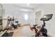 Home gym featuring a Peloton bike and other fitness equipment at 6092 Carlisle Ln, Alpharetta, GA 30022
