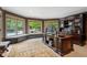 Bright home office with built-in shelving and pool view at 6092 Carlisle Ln, Alpharetta, GA 30022