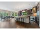 Open concept kitchen with large island, stainless steel appliances, and hardwood floors at 6092 Carlisle Ln, Alpharetta, GA 30022
