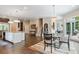 Eat-in kitchen with large island, hardwood floors, and access to outdoor patio at 6092 Carlisle Ln, Alpharetta, GA 30022