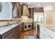 Modern kitchen with dark wood cabinets, granite countertops, and stainless steel appliances at 6092 Carlisle Ln, Alpharetta, GA 30022