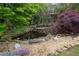 Serene koi pond with rock waterfall and lush landscaping at 6092 Carlisle Ln, Alpharetta, GA 30022