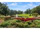 Landscaped garden with fountain overlooking a pond and homes at 6092 Carlisle Ln, Alpharetta, GA 30022
