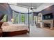 Spacious main bedroom with a king-size bed, fireplace, and private sitting area at 6092 Carlisle Ln, Alpharetta, GA 30022