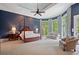 Serene main bedroom with a four-poster bed, sitting area, and access to private balcony at 6092 Carlisle Ln, Alpharetta, GA 30022