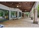 Covered patio with stone flooring, ceiling fan, and outdoor fireplace at 6092 Carlisle Ln, Alpharetta, GA 30022