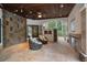 Relaxing covered patio with seating area and stone fireplace at 6092 Carlisle Ln, Alpharetta, GA 30022
