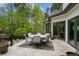 Outdoor patio with seating area, offering a relaxing space to enjoy the wooded views at 6092 Carlisle Ln, Alpharetta, GA 30022