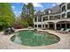 Luxury estate home with a freeform pool and expansive patio at 6092 Carlisle Ln, Alpharetta, GA 30022