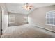 Spacious carpeted bedroom with ceiling fan and multiple windows at 7167 Rigel Sw Bnd, Atlanta, GA 30331