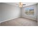 Spacious bedroom with ceiling fan and large window at 7167 Rigel Sw Bnd, Atlanta, GA 30331