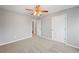 Well-lit bedroom with ceiling fan and adjacent bathroom at 7167 Rigel Sw Bnd, Atlanta, GA 30331
