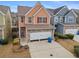 Two-story townhome with stone accents and a two-car garage at 7167 Rigel Sw Bnd, Atlanta, GA 30331