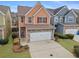Two-story townhome with stone accents and a two-car garage at 7167 Rigel Sw Bnd, Atlanta, GA 30331