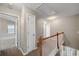 Upstairs hallway with carpet, doors to bedrooms and linen closet at 7167 Rigel Sw Bnd, Atlanta, GA 30331