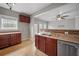 Kitchen boasts wood cabinets, stainless steel appliances, and tile floor at 7167 Rigel Sw Bnd, Atlanta, GA 30331