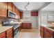 Kitchen features wood cabinets, stainless steel appliances, and tile floor at 7167 Rigel Sw Bnd, Atlanta, GA 30331