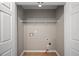 Simple laundry room with wire shelving and hookups at 7167 Rigel Sw Bnd, Atlanta, GA 30331