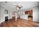 Open living room with hardwood floors, kitchen island and fireplace at 7167 Rigel Sw Bnd, Atlanta, GA 30331