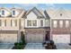 Three-story townhome with attached garage and modern exterior finishes at 759 Arbor Crowne Dr, Lawrenceville, GA 30045