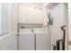 Laundry room with washer, dryer, and overhead cabinets at 340 Shyrewood Dr, Lawrenceville, GA 30043