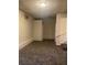 Finished basement area with neutral walls and carpeting at 5904 Heatherwood Ln, Riverdale, GA 30296