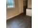 Simple dining area with gray vinyl flooring and a window at 5904 Heatherwood Ln, Riverdale, GA 30296