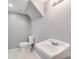 Basement powder room with gray walls, white vanity, and tiled floor at 7077 Milam Rd, Winston, GA 30187