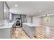 Modern kitchen with gray cabinets, quartz countertops, and hardwood floors at 7077 Milam Rd, Winston, GA 30187