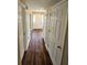 Long hallway with wood-look flooring and storage at 3987 Cameron Close, Ellenwood, GA 30294