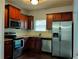 Modern kitchen with dark wood cabinets, stainless steel appliances, and granite countertops at 5462 Union Hill Ct, Union City, GA 30291