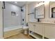Modern bathroom with white vanity, marble shower, and hardwood floors at 6685 Buckhurst Trl, Atlanta, GA 30349