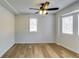 Well-lit bedroom, hardwood floors, and ceiling fan at 6685 Buckhurst Trl, Atlanta, GA 30349