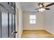Hardwood floors and ceiling fan in this bright bedroom at 6685 Buckhurst Trl, Atlanta, GA 30349