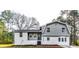 Newly renovated house featuring gray siding, white brick, and a landscaped yard at 6685 Buckhurst Trl, Atlanta, GA 30349