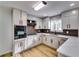 Renovated kitchen with white cabinets and dark brown tile backsplash at 6685 Buckhurst Trl, Atlanta, GA 30349