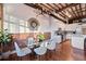 Open concept dining area with kitchen access, exposed brick, and hardwood floors at 150 Walker Sw St # 5, Atlanta, GA 30313