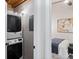 Stackable washer and dryer in a small laundry room with bedroom access at 150 Walker Sw St # 5, Atlanta, GA 30313
