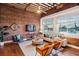 Spacious living area with exposed brick, hardwood floors, and large windows at 150 Walker Sw St # 5, Atlanta, GA 30313