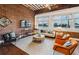 Living area features exposed brick wall, hardwood floors, and comfy seating at 150 Walker Sw St # 5, Atlanta, GA 30313