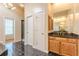 Main bathroom with granite countertops and dark tile floors at 5170 Stone Croft Trl, Atlanta, GA 30331