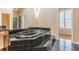 Bathroom with large oval jacuzzi tub and dark tile at 5170 Stone Croft Trl, Atlanta, GA 30331