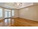 Bright bedroom featuring hardwood floors and French doors leading to a patio at 5170 Stone Croft Trl, Atlanta, GA 30331
