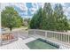 Deck overlooking backyard with trees and a glimpse of the neighborhood at 5170 Stone Croft Trl, Atlanta, GA 30331