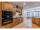 Kitchen boasts wood cabinets, granite countertops, and stainless steel appliances at 5170 Stone Croft Trl, Atlanta, GA 30331