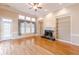 Open living room with hardwood floors, built-in shelving and fireplace at 5170 Stone Croft Trl, Atlanta, GA 30331