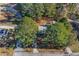 Aerial view showing house nestled among trees, driveway and street at 9220 Bayou Ln, Jonesboro, GA 30238