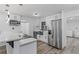 Updated kitchen boasting white cabinets, quartz countertops, and a farmhouse sink at 9220 Bayou Ln, Jonesboro, GA 30238