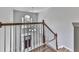 Elegant staircase with wood railings overlooking the foyer at 1633 Moonlake Nw Trl, Kennesaw, GA 30152